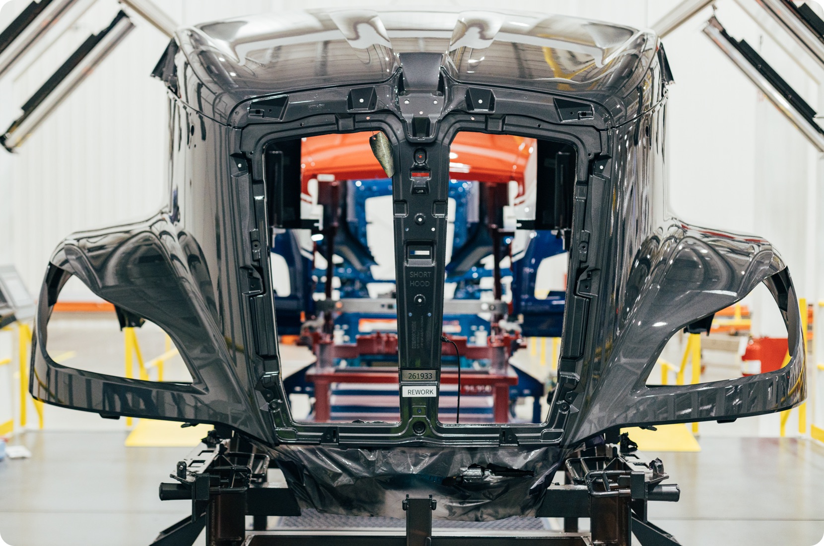 Automotive industry photo showing a heavy truck hood in production.