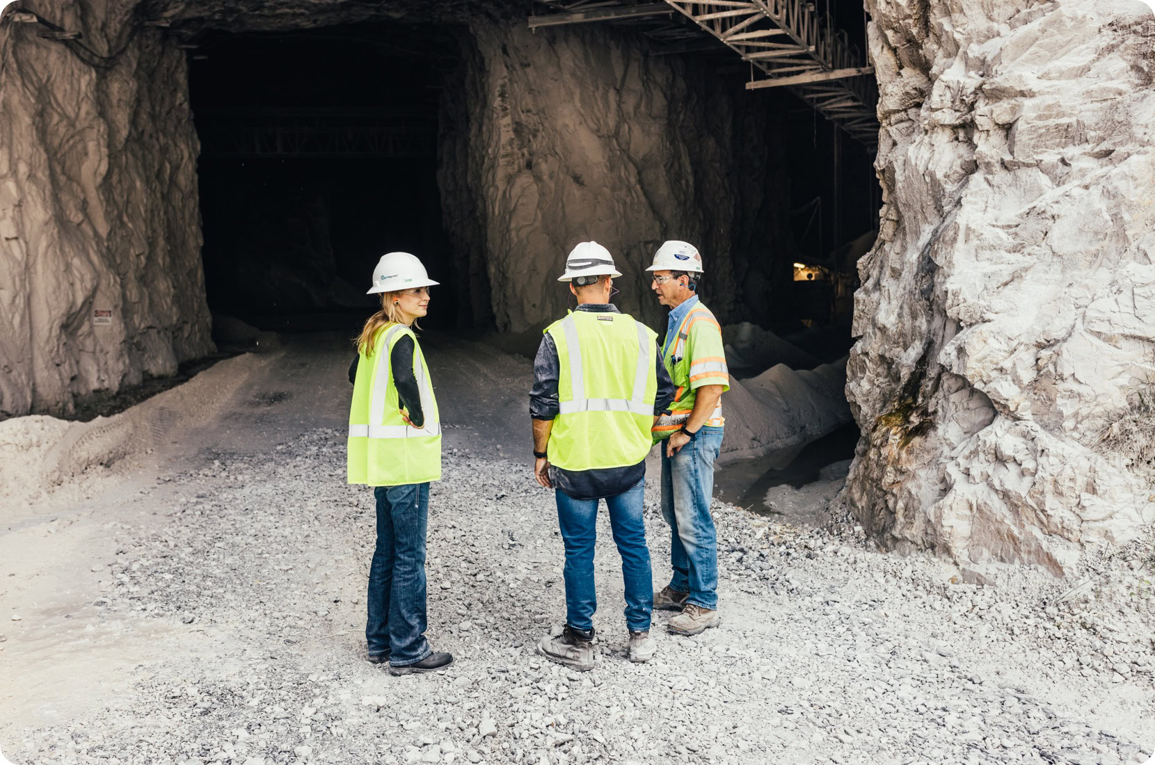 Engineers discuss machine health in a mine entrance, on location.