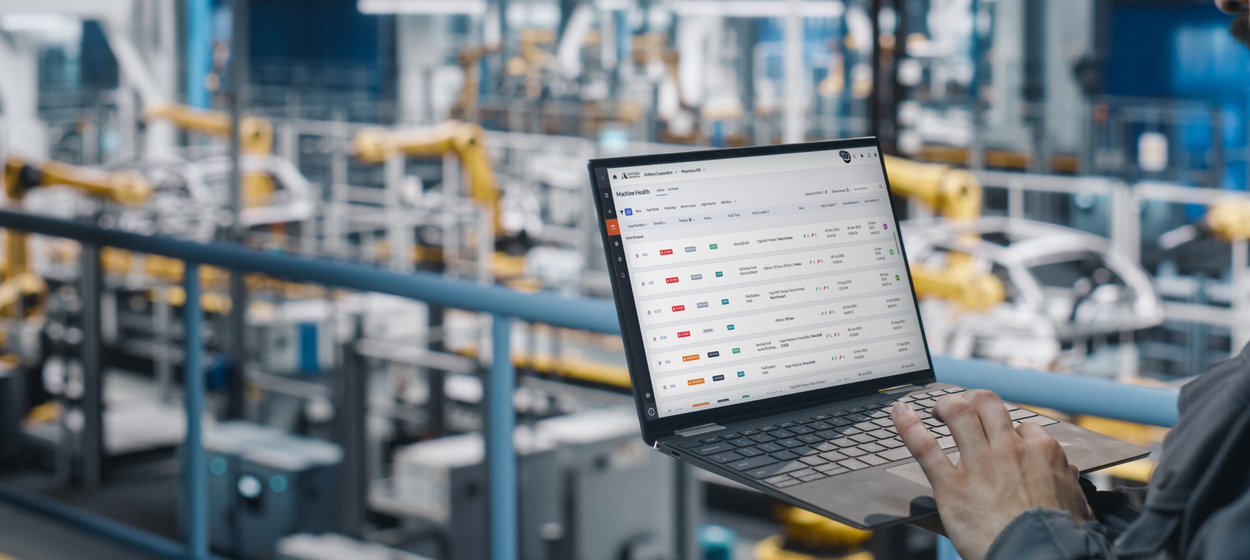 SMARTdiagnostics displayed on a latop while a person monitors machine health on an assembly line.