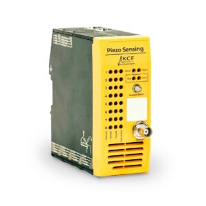 Piezo sensing hub with yellow faceplate, and black sides and top visible. Many inputs and connections are available on the faceplate.