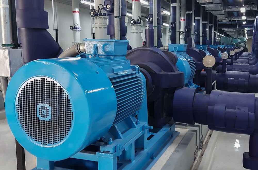 Motors and pumps with large pipes in a utilities plant.