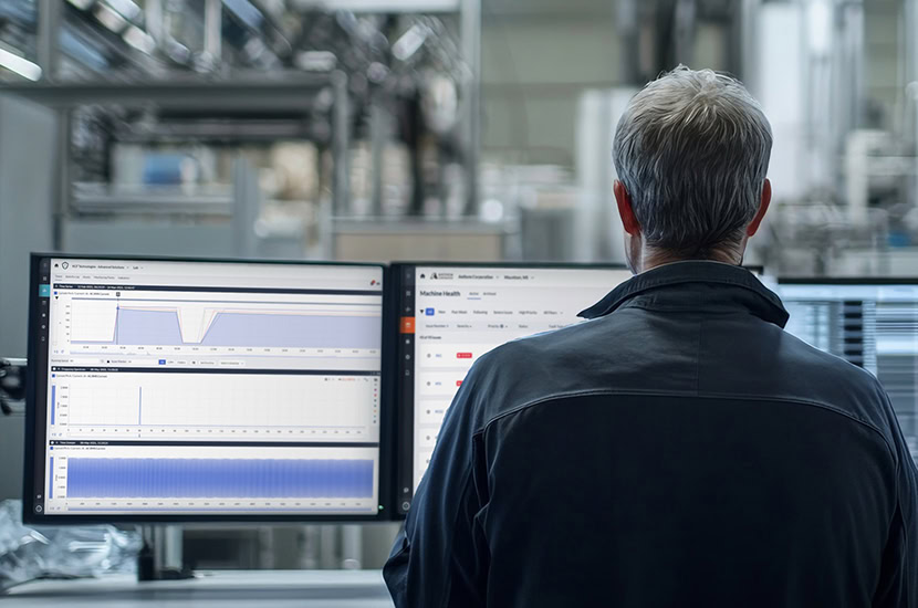 Engineer operating predictive maintenance software to keep the plant running at peak efficiency.