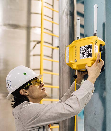 KCF Technician places a SMARTdiagnostics hub in an industrial setting.