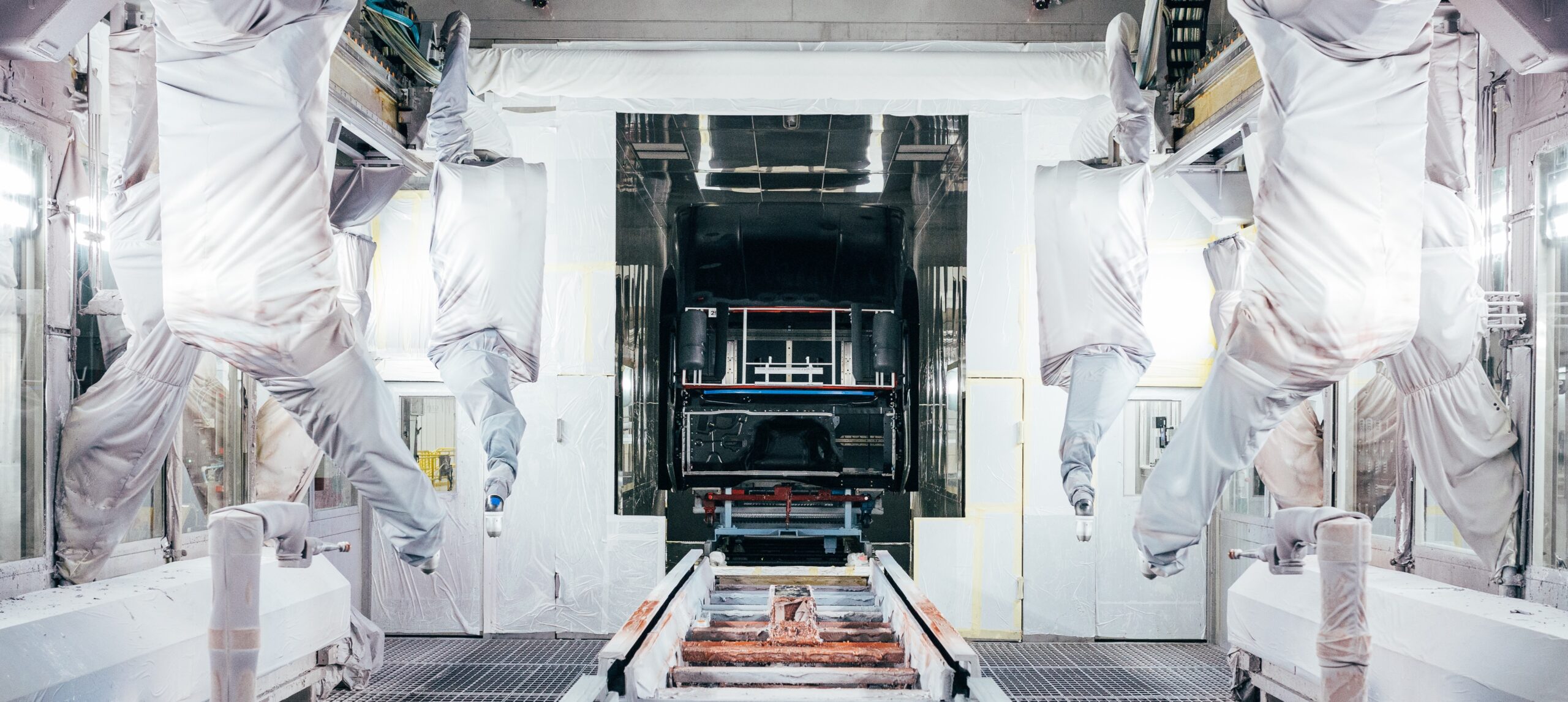 Manufacturing clean room showing covers on industrial equipment and interor of controlled area.