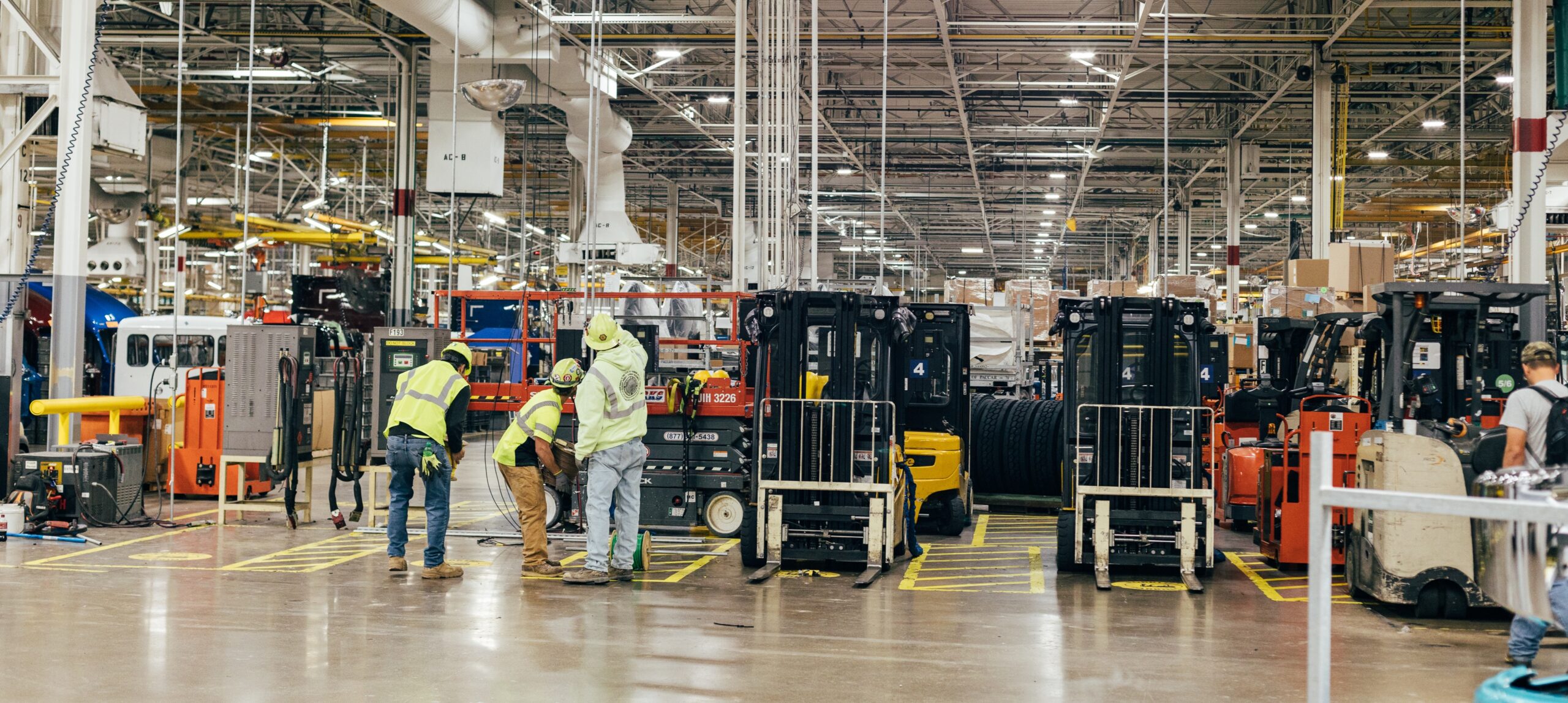 Crew in a warehouse works together to determine overall equipment effectiveness.