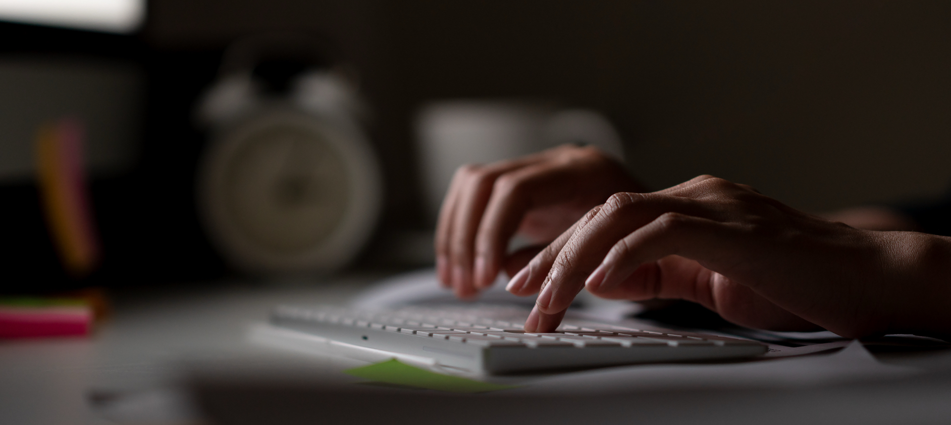 Hands typing on a flat keyboard.