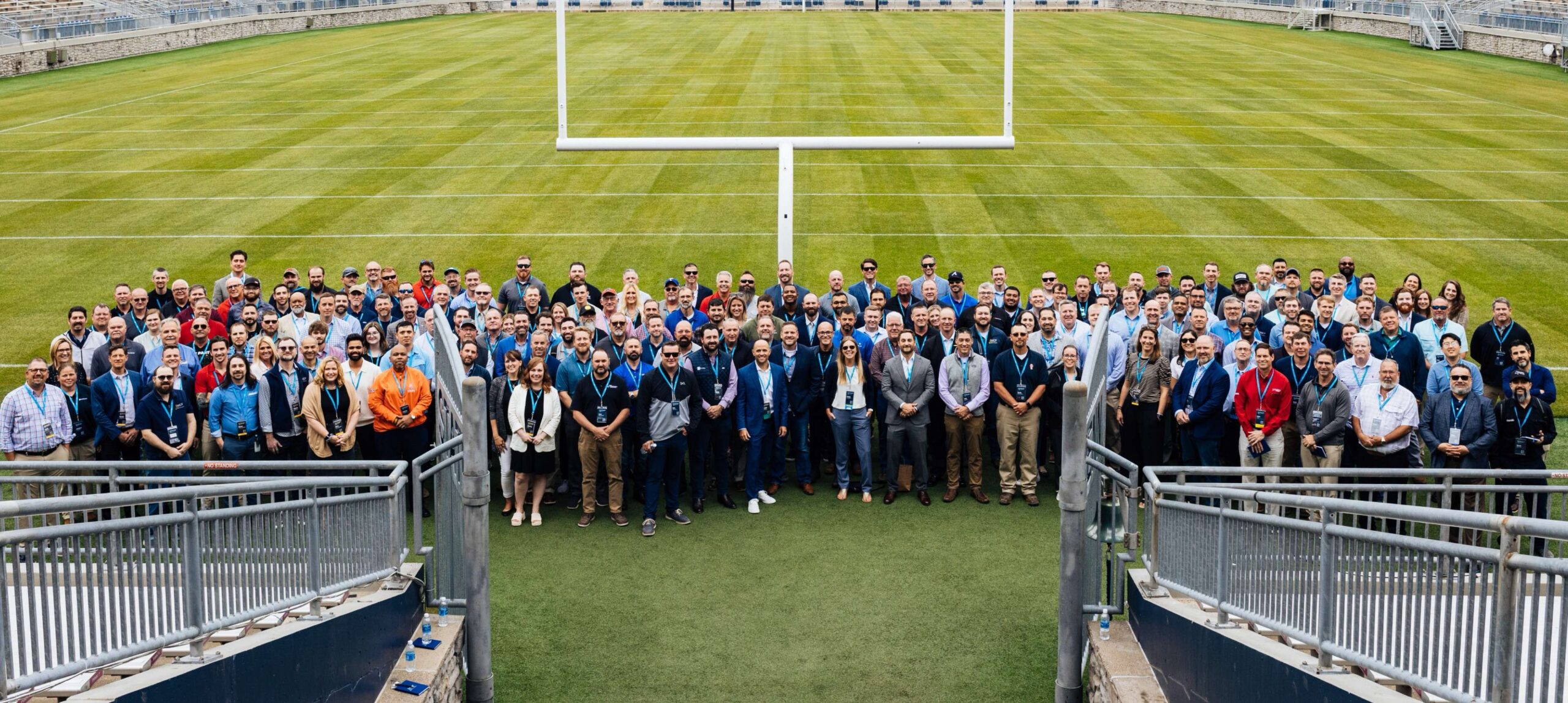 KCF Technologies team photographed on a football field.