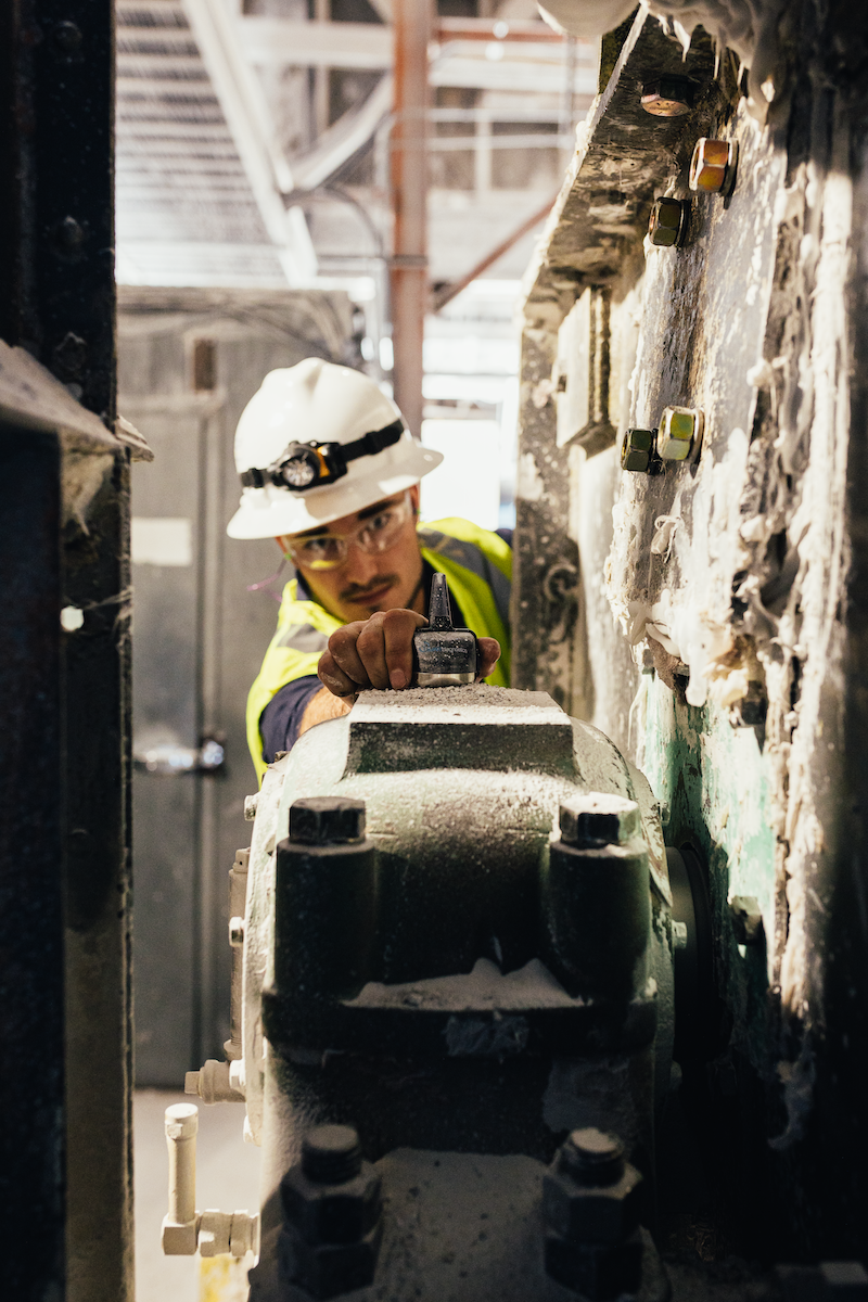 maintenance professional placing sensor on machinery